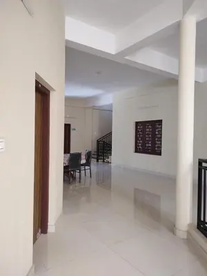 an empty room with a pillar and a table at Bridgettine Paradise in Sultan Bathery