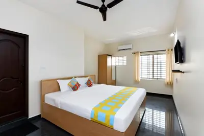 a bedroom with a bed and a window at Stayz Royale - Mysuru near Mysuru Palace in Mysore