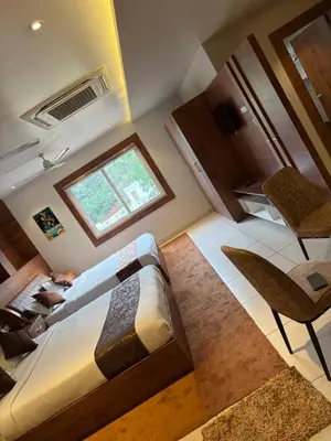 an overhead view of a bedroom with a bed and a window at Raravies family restaurent Mattanur,Near Kannur airport in Chāvasseri