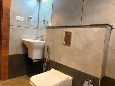 a bathroom with a sink and a toilet at Raravies family restaurent Mattanur,Near Kannur airport in Chāvasseri