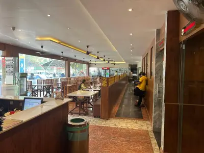 a restaurant with a person standing at the counter at Raravies family restaurent Mattanur,Near Kannur airport in Chāvasseri