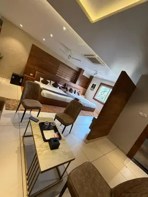 a hotel room with a bed and a living room at Raravies family restaurent Mattanur,Near Kannur airport in Chāvasseri