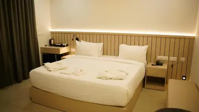 a hotel room with a large bed with towels on it at VOX holiday in Palakkad