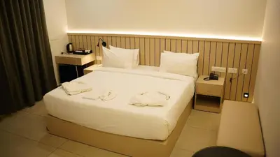 a hotel room with a large bed with towels on it at VOX holiday in Palakkad