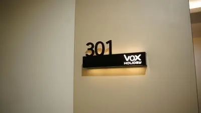 a white door with a black sign on it at VOX holiday in Palakkad