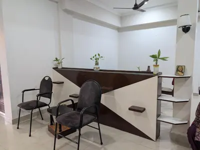 a bar with two chairs and a counter in a room at Eva's Homestay at Cherai in North Paravur