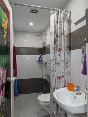 a bathroom with a sink and a toilet at Eva's Homestay at Cherai in North Paravur