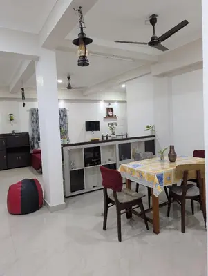 a living room with a table and some chairs at Eva's Homestay at Cherai in North Paravur