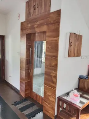 a wooden door in a room with a table at GG Residency INN in Palakkad