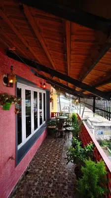 an outdoor patio with a table and chairs and a building at Steeva service apartment in Mysore