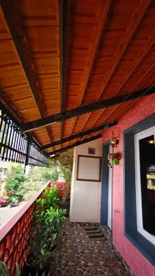 a building with a wooden ceiling and a white door at Steeva service apartment in Mysore