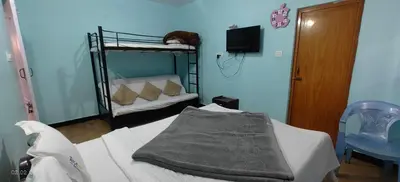 a hospital room with a bed and a bunk bed at Jay bahadur Cottages and home stay in Ooty