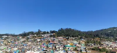 an aerial view of a city on a hill at Jay bahadur Cottages and home stay in Ooty