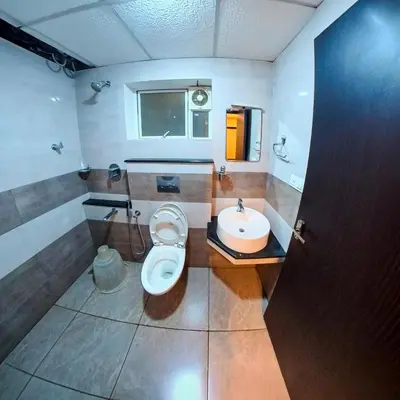 a bathroom with a toilet and a sink at Gokulam suits guruvayur in Guruvāyūr