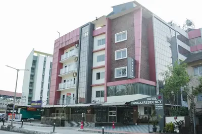 a pink building on the side of a street at Gokulam suits guruvayur in Guruvāyūr