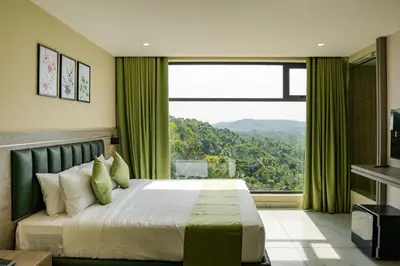a bedroom with a large bed and a large window at Chaliyar Resorts