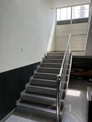 a staircase in a building with a stair case at Hotel Alka Inn Residency Wayanad in Sultan Bathery