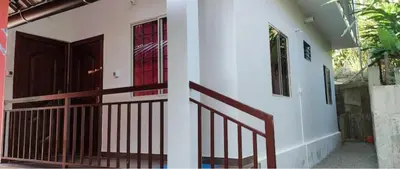 a house with a red window and a door at hilldown cottage in Ooty