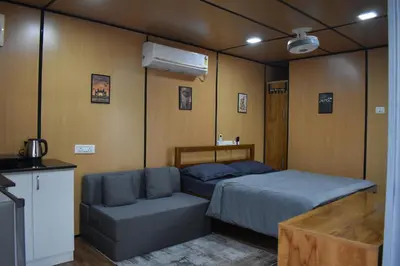 a bedroom with a bed and a couch in it at GUDU by Coexist in Mysore
