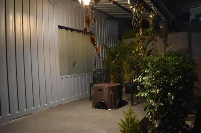 a patio with a bench and some plants on it at GUDU by Coexist in Mysore