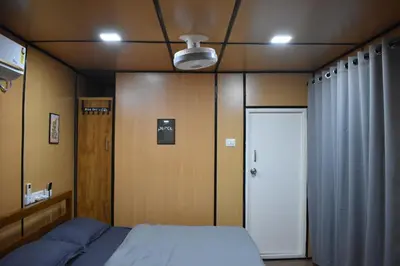 a bedroom with a bed and a white door at GUDU by Coexist in Mysore