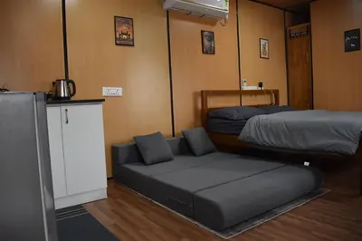 a room with two bunk beds and a couch at GUDU by Coexist in Mysore