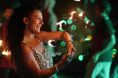 a woman is holding a bunch of lights at Spirit of the Wild Mountain Retreat in Palakkad