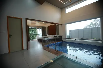 a bathroom with a swimming pool in a house at Ymoon Mountain Resort Wayanad in Koroth