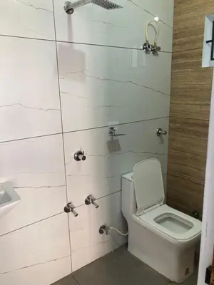 a bathroom with a toilet and a sink at Valiyaveettile in Alwaye