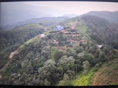 a house on top of a hill with trees at Spirit of the Wild Mountain Retreat Attapadi in Attappādi
