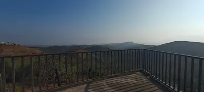 a balcony with a view of the mountains at Spirit of the Wild Mountain Retreat Attapadi in Attappādi