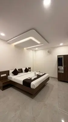 a bedroom with a large bed in a room at SKB Suites in Mysore