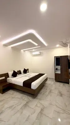 a bedroom with a large bed in a room at SKB Suites in Mysore