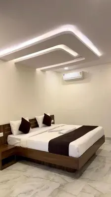 a bedroom with a large bed in a room at SKB Suites in Mysore