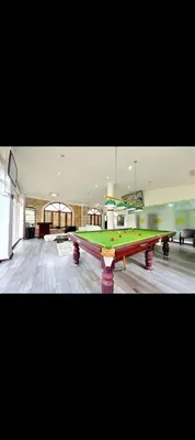 a large pool table in a large room at The 77 estate stay coorg in Suntikoppa