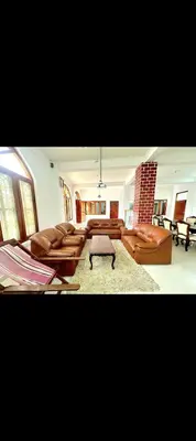 a large living room with couches and a table at The 77 estate stay coorg in Suntikoppa