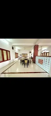a living room with a table in the middle of it at The 77 estate stay coorg in Suntikoppa