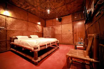 a bedroom with a bed in a wooden room at Bali bamboo in Padinjarathara