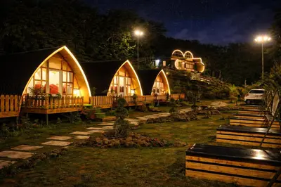 a row of domed houses at night at The Farmville kodaikanal in Kodaikānāl