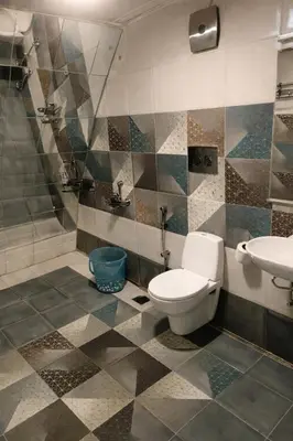 a bathroom with a toilet and a sink at The Farmville kodaikanal in Kodaikānāl