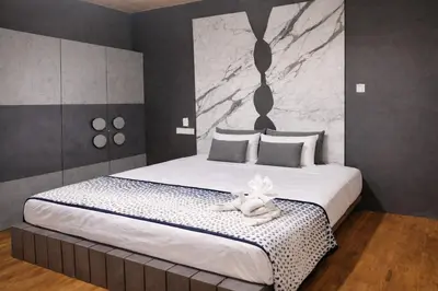 a bedroom with a large bed with a stuffed animal on it at The Farmville kodaikanal in Kodaikānāl