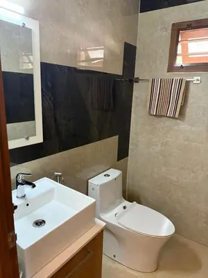 a bathroom with a white toilet and a sink at Premium house near Cochin Airport for NRI families in Nedumbassery