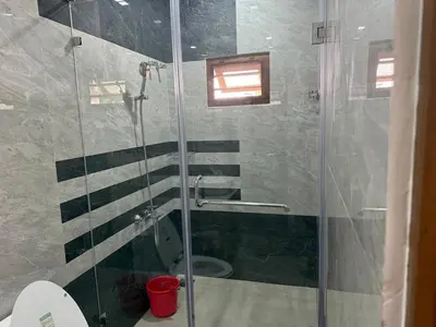 a bathroom with a glass shower with a toilet at Premium house near Cochin Airport for NRI families in Nedumbassery