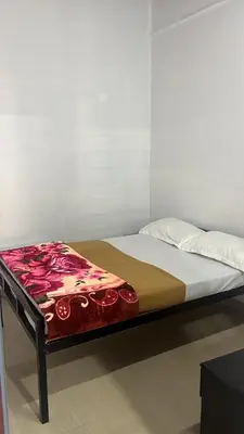a bed in a room with a bedvisor with flowers on it at Pookode Service Villa in Vythiri