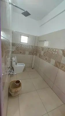 a bathroom with a toilet and a sink at Caramel stay in Marayoor