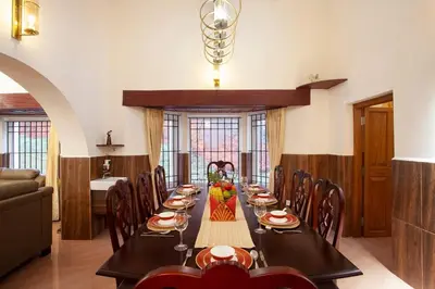 a dining room with a long table and chairs at Wyncroft Bed and Breakfast, Heritage Bungalow at Kotagiri in Kotagiri