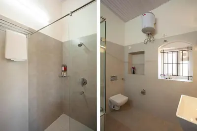 a bathroom with a shower and a toilet and a sink at Wyncroft Bed and Breakfast, Heritage Bungalow at Kotagiri in Kotagiri