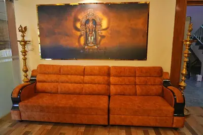 a couch in a room with a painting on the wall at Shri Bhagawathi Residency in Palani