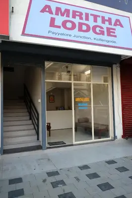 a store front of a building with a window at Amritha Lodge in Kollengode