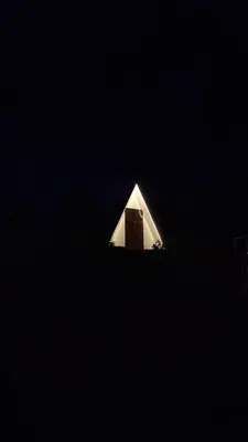 a small white building with a door in the dark at Secret valley vattavada in Vattavada